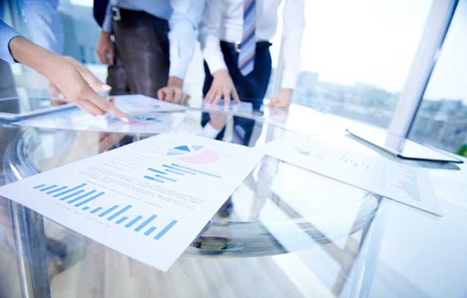 Conference table with papers that have data graphs