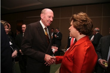 Janet Walsh shaking hands with businessman