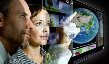global-business-view Woman and man looking at transparent screen with a globe on it