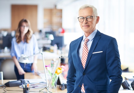 how-can-we-help-competitive-advantage Businessman with blue suit, light blue shirt and red striped tie.