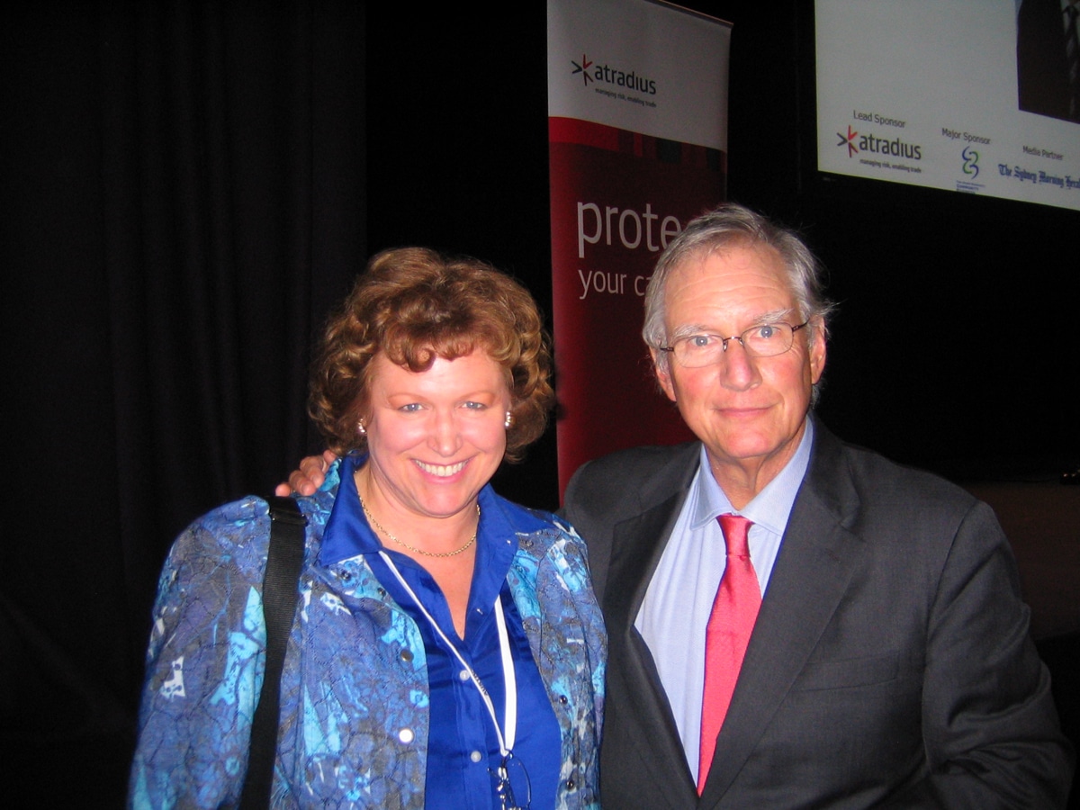 Janet Walsh and Tom Peters wearing business attire pose for picture